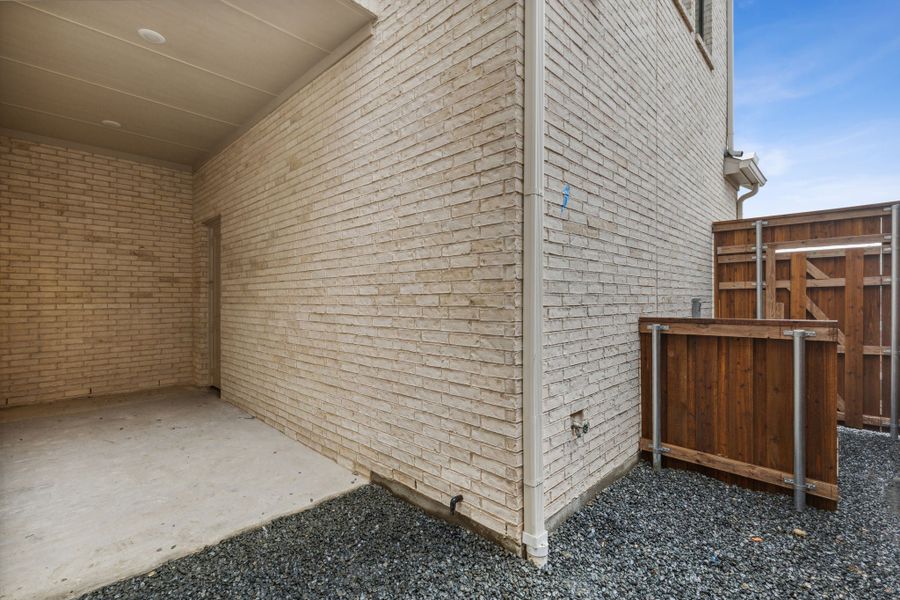 Exterior details and patio area of a home in Newman Village Townhomes, Frisco (Image 14).
