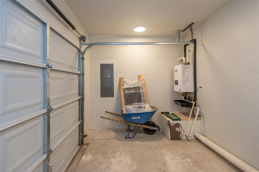 Gold cart garage with  featuring tankless water heater and plumbed for extra frig or frezer