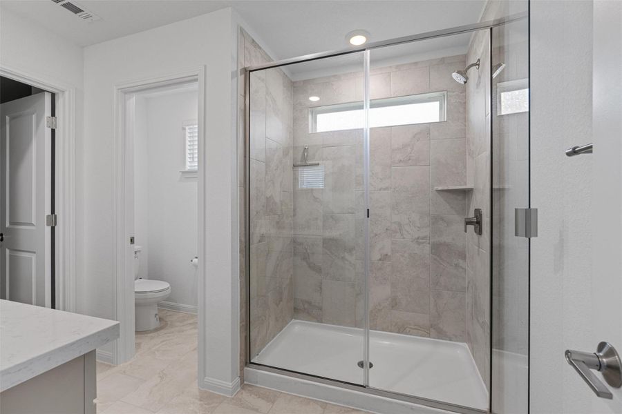 Primary bathroom features a walk-in shower and dual vanity