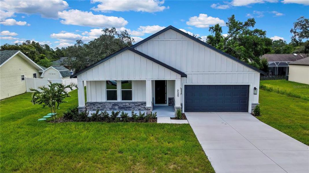 Front exterior of a new home in , Spring Hill, FL, highlighting curb appeal (Image 25).