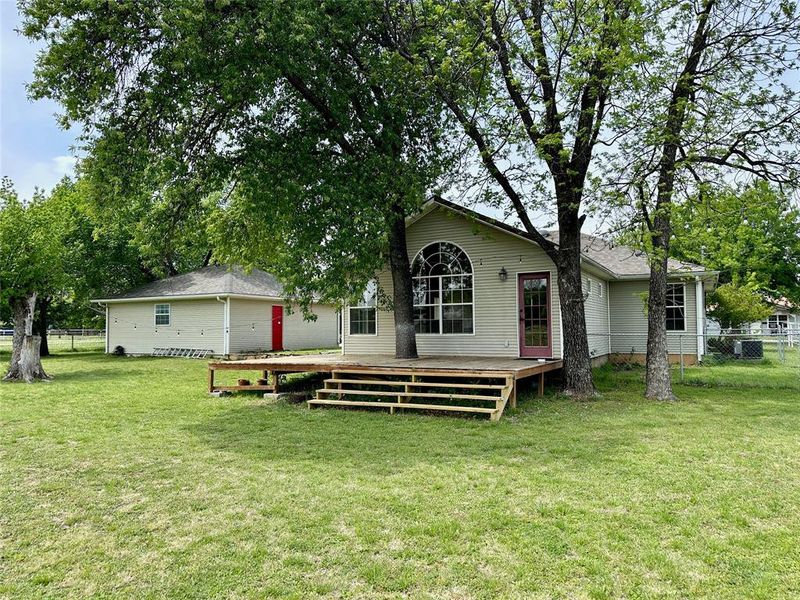 Rear view of property featuring a wooden deck