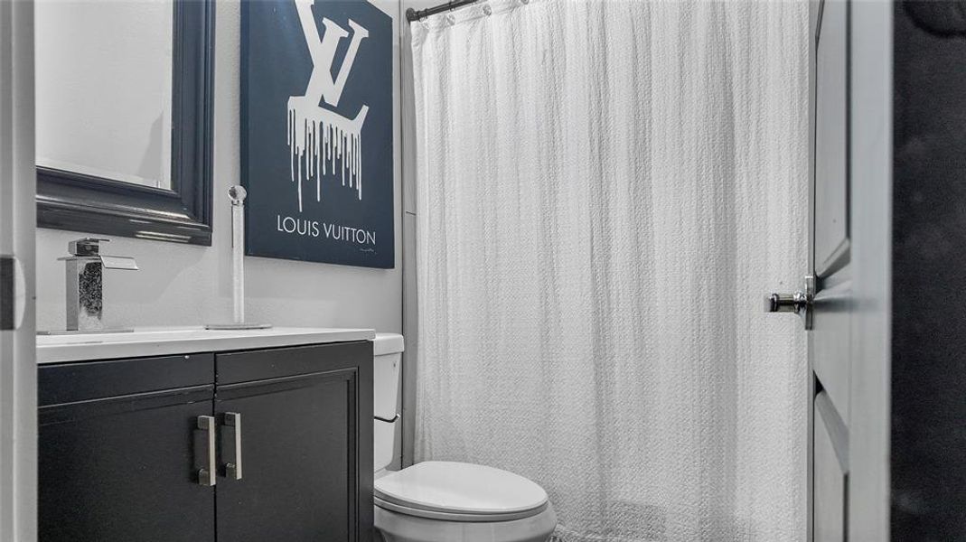 Bathroom featuring vanity and a shower with shower curtain