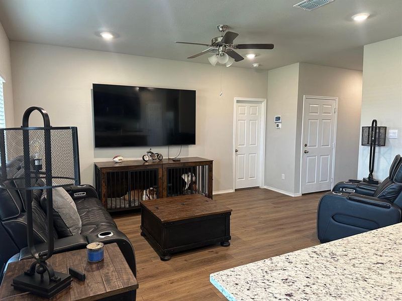 Living area featuring wood finished floors, recessed lighting, and ceiling fan