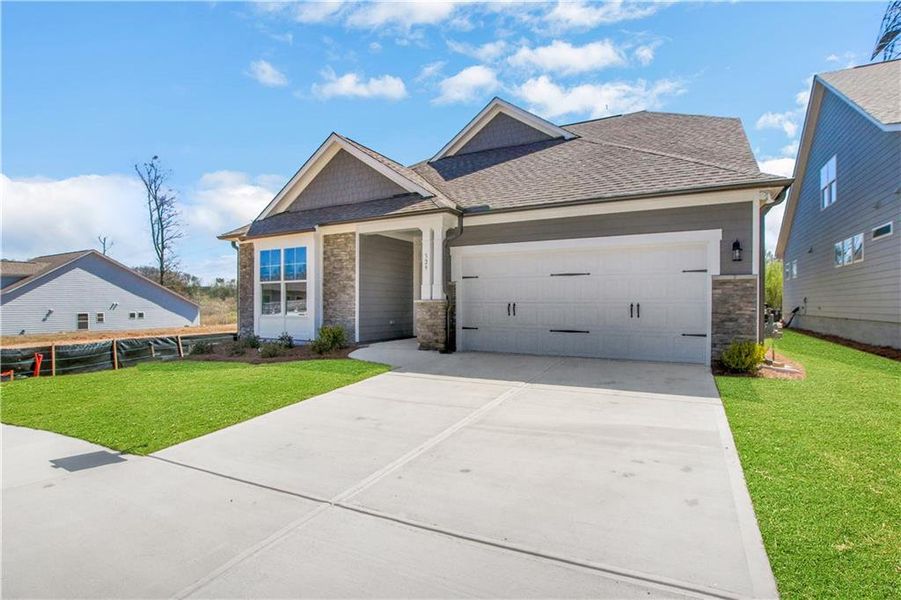 Front exterior of a new home in Marble Tree, Ball Ground, GA, highlighting curb appeal (Image 1). Front exterior of a new home in Marble Tree, Ball Ground, GA, highlighting curb appeal (Image 1).