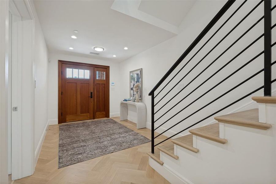 Wide entry way leads way to downstairs bedroom, mudroom, and utility room, along with access to the upstairs living areas. Wide entry way leads way to downstairs bedroom, mudroom, and utility room, along with access to the upstairs living areas.