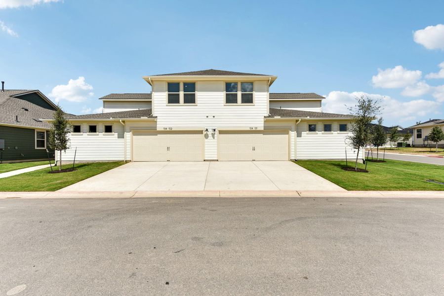 View of front facade featuring concrete driveway, a front lawn, and a shingled roof View of front facade featuring concrete driveway, a front lawn, and a shingled roof