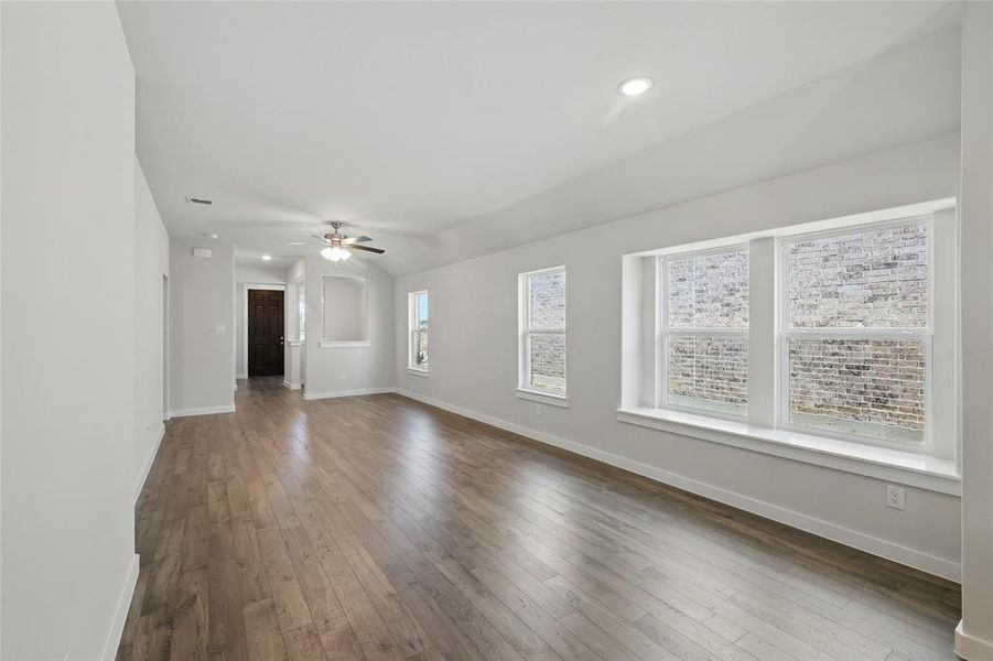 Unfurnished living room featuring wood-type flooring, ceiling fan, and recessed lighting Unfurnished living room featuring wood-type flooring, ceiling fan, and recessed lighting