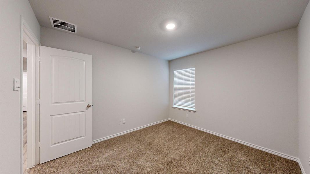 Carpeted empty room with baseboards