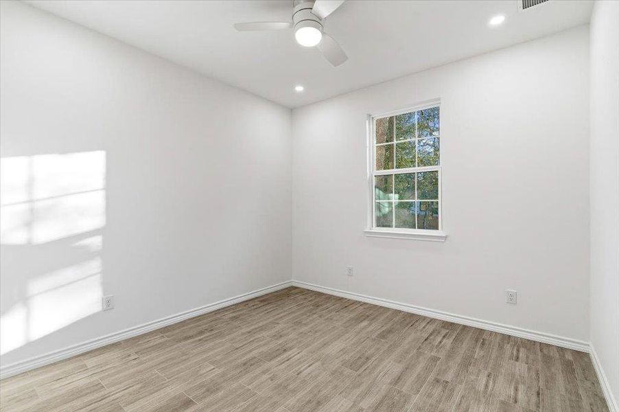 Spare room featuring light wood finished floors, recessed lighting, and ceiling fan