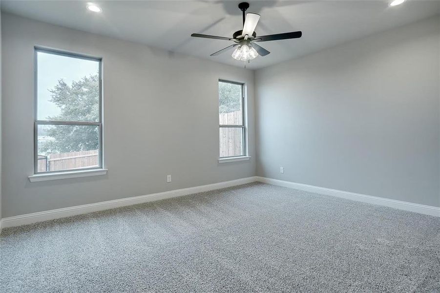 Carpeted empty room with recessed lighting and ceiling fan