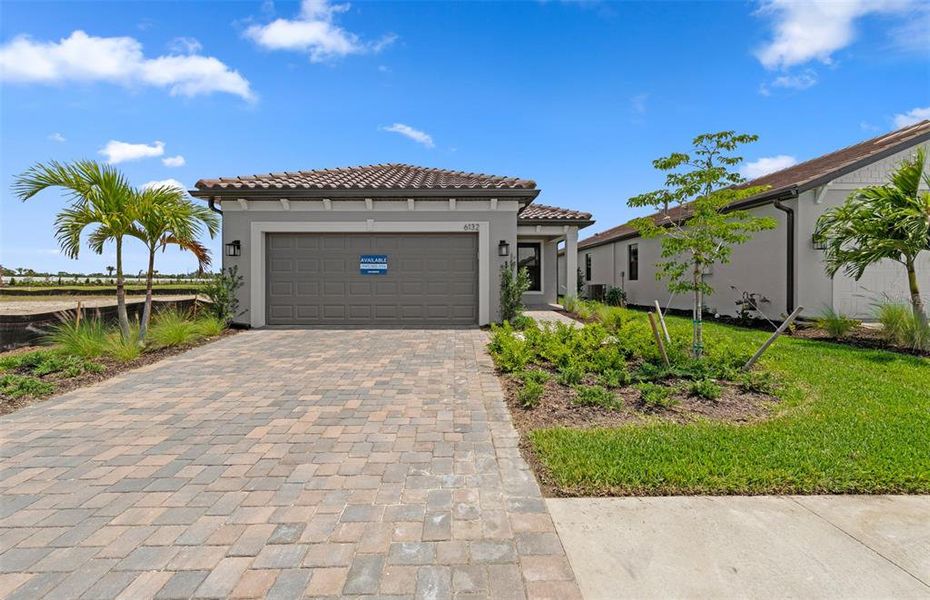 Front exterior of a new home in Talon Preserve on Palmer Ranch, Nokomis, FL, highlighting curb appeal (Image 2). Front exterior of a new home in Talon Preserve on Palmer Ranch, Nokomis, FL, highlighting curb appeal (Image 2).
