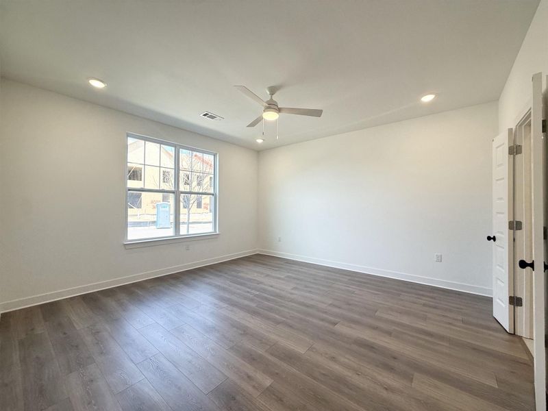 Spare room featuring recessed lighting, ceiling fan, and dark wood finished floors