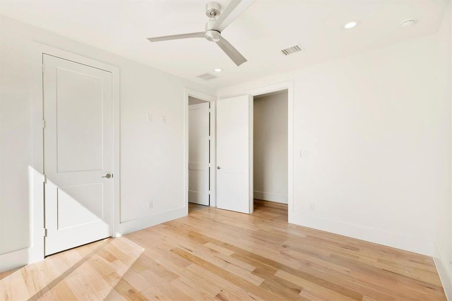 Unfurnished bedroom with light hardwood / wood-style flooring and ceiling fan