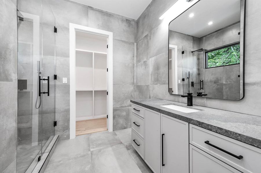 En suite bathroom with walk-in shower and LED under light wall-mounted vanity.