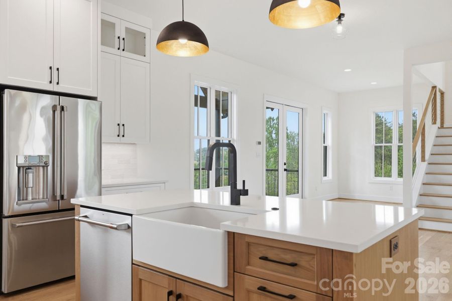 Kitchen island feat. farmhouse apron sink and dishwasher