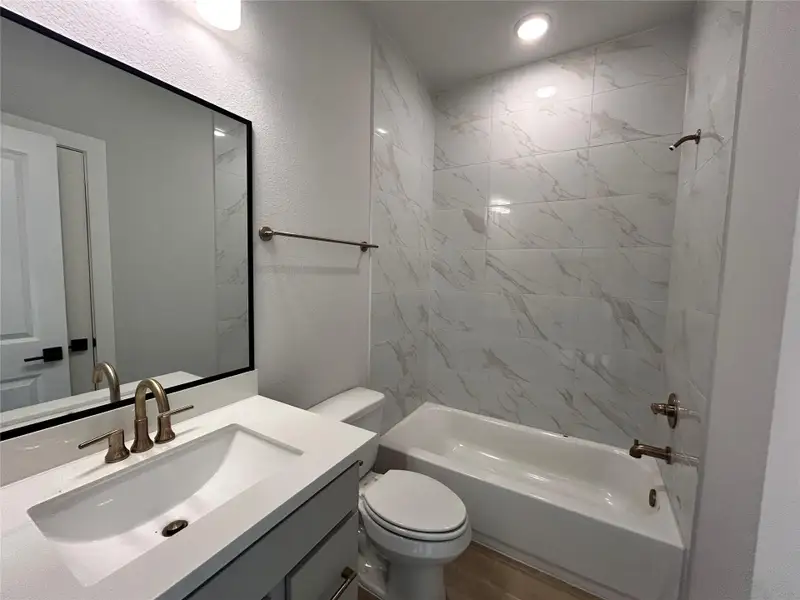 **REPRESENTATIVE PHOTO** The downstairs secondary bathroom combines practicality and style with modern fixtures, easy access, and ideal for guests. **REPRESENTATIVE PHOTO** The downstairs secondary bathroom combines practicality and style with modern fixtures, easy access, and ideal for guests.