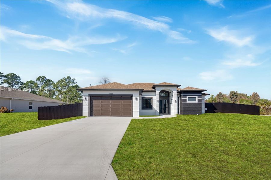 Front exterior of a new home in , Lehigh Acres, FL, highlighting curb appeal (Image 24).