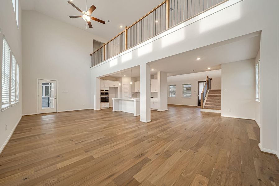 Light and bright family room open to the kitchen and breakfast room with door to the back balcony.