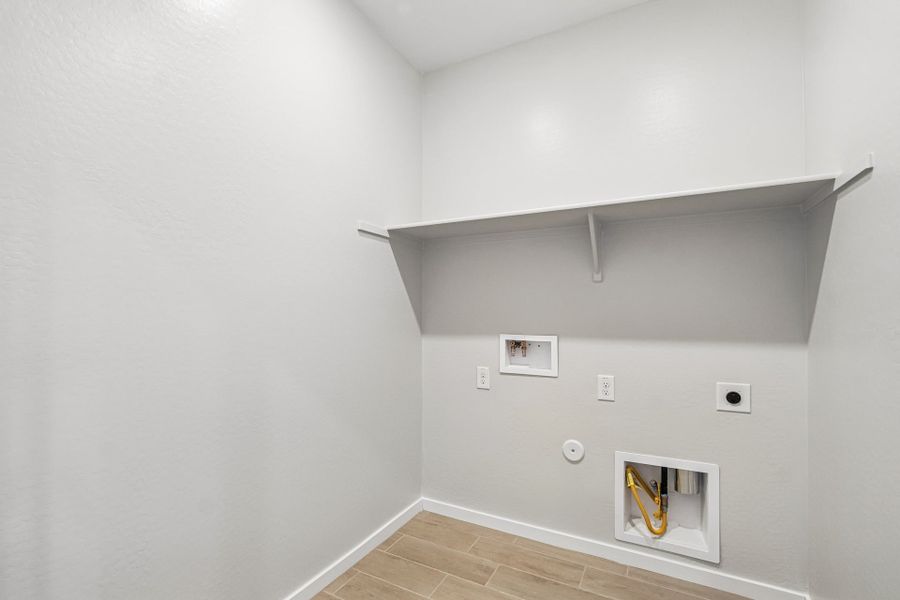 A white room with a shelf and a white wall.