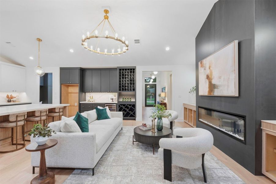 Soaring pitched ceiling adds volume and architectural interest to the living room, creating a bright, open feel at the heart of the home.