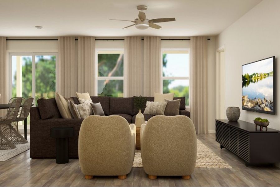 A living room with a couch and a fan.