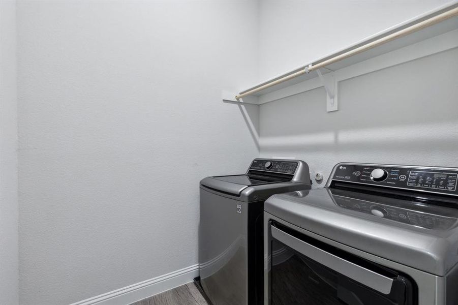 Laundry room has a long shelf & clothes hanging rod.  Note:  The extra large washer & dryer are not included.