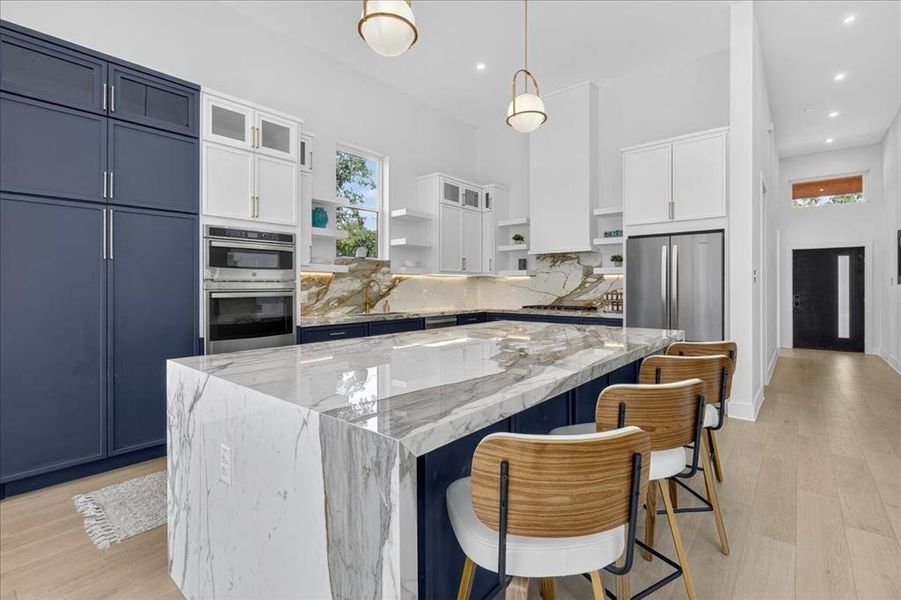 Kitchen featuring gas range, custom oak cabinets, and designer finishes