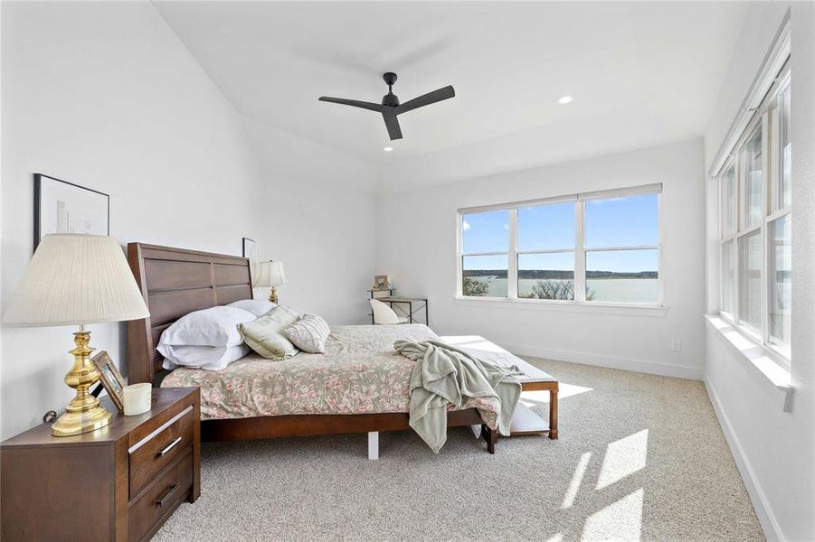 Bedroom featuring light colored carpet, a ceiling fan, and recessed lighting