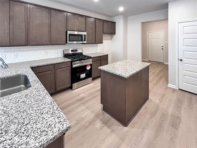 The Cardinal II- Spacious Kitchen with Ample Cabinet and Countertop Space. Home under construction, photo used for illustrative purposes only, colors and options will vary. The Cardinal II- Spacious Kitchen with Ample Cabinet and Countertop Space. Home under construction, photo used for illustrative purposes only, colors and options will vary.