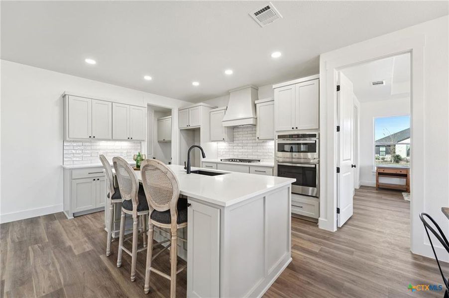 Culinary creations await in this well-appointed kitchen, featuring a spacious island and modern finishes. Culinary creations await in this well-appointed kitchen, featuring a spacious island and modern finishes.
