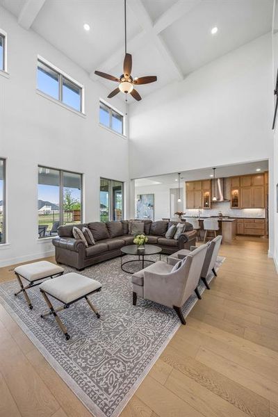 Living area featuring recessed lighting, light wood-style floors, ceiling fan, and coffered ceiling