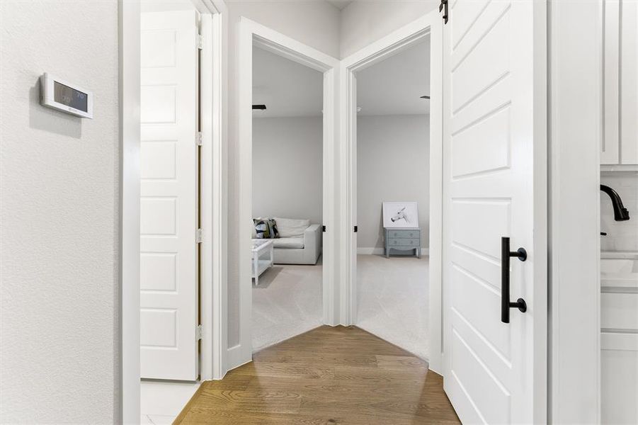 Hallway with wood finished floors and a barn door