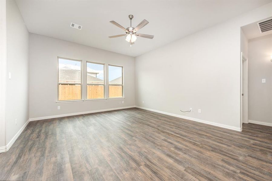 Unfurnished room with ceiling fan and dark hardwood / wood-style flooring