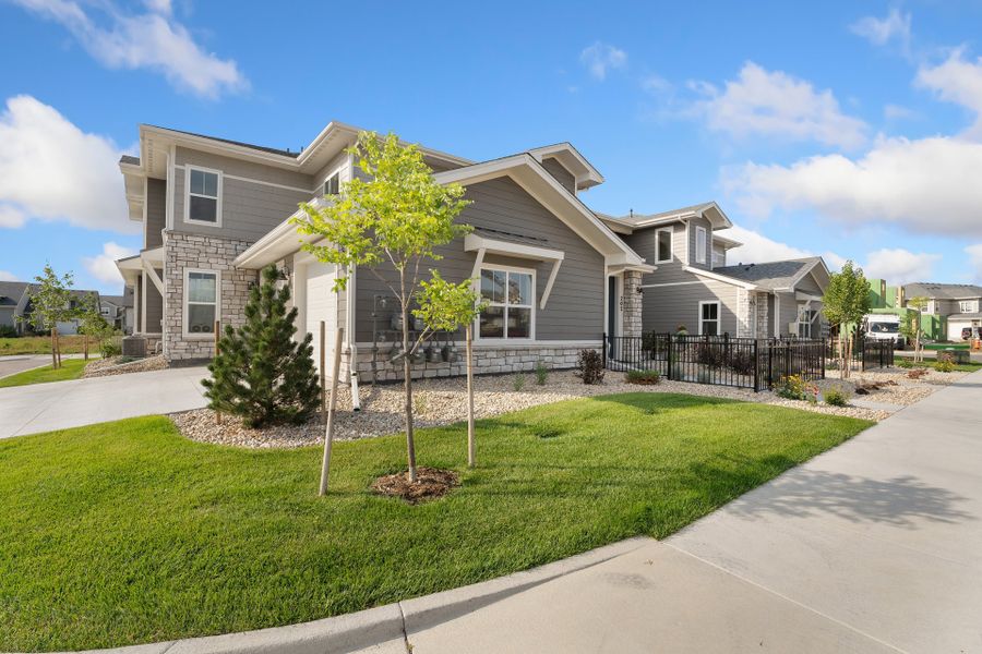 Front exterior of a new home in The Lakes at Centerra, Loveland, CO, highlighting curb appeal (Image 2).