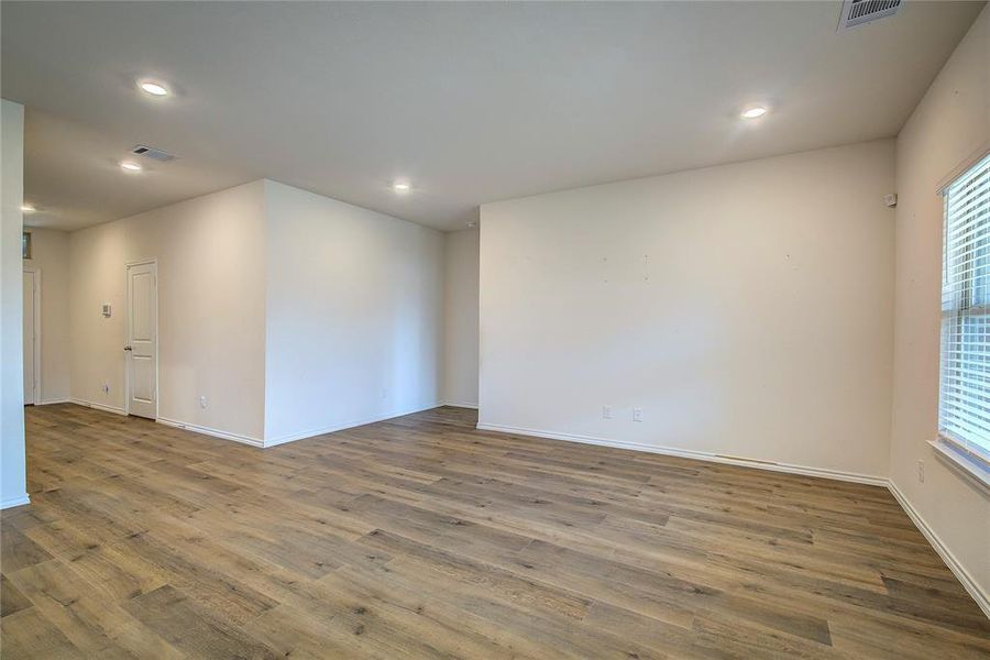 Unfurnished room with wood finished floors and recessed lighting