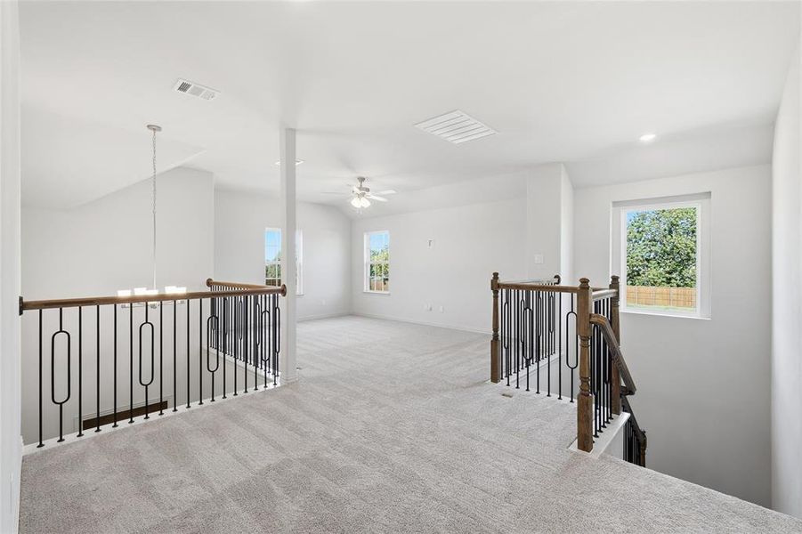 Corridor featuring an upstairs landing, carpet floors, a chandelier, and recessed lighting