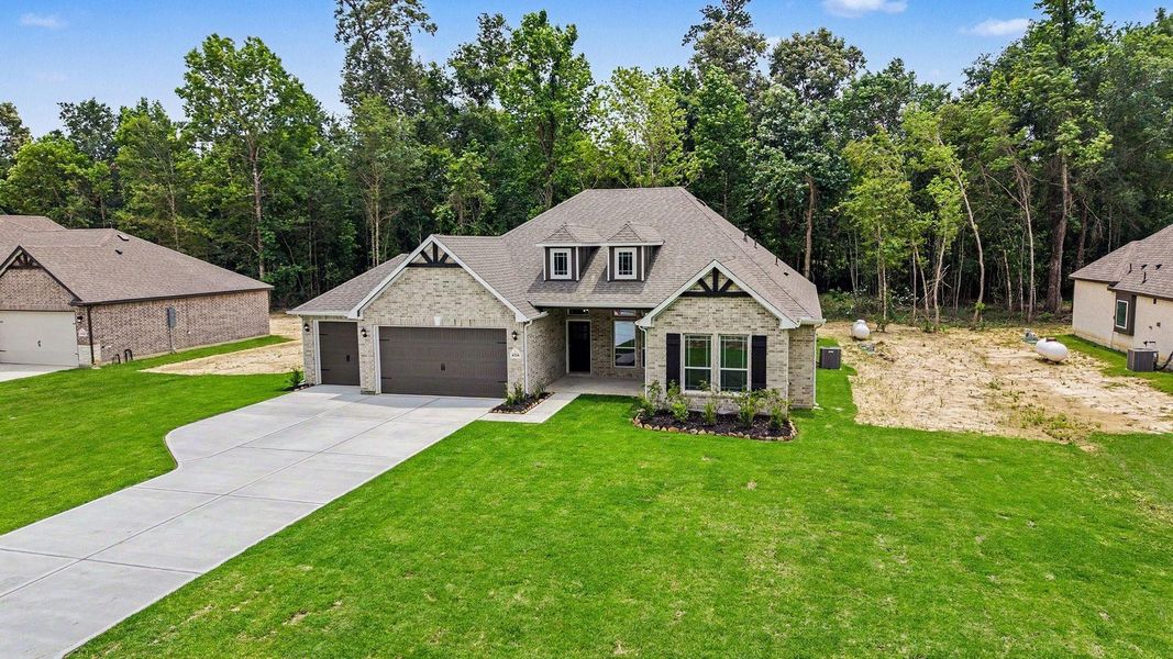 Front exterior of a new home in Encino Estates, Dayton, TX, highlighting curb appeal (Image 19).