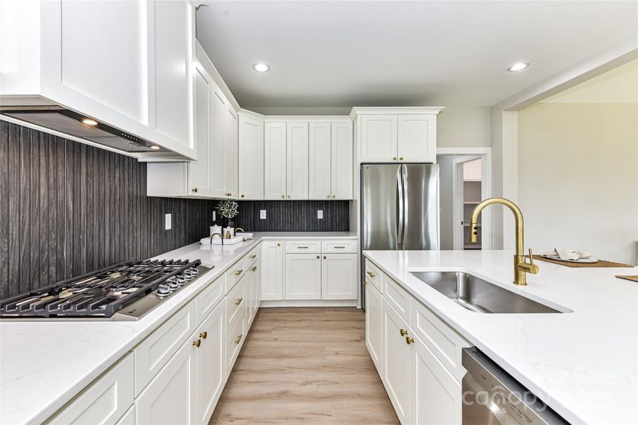 Upgrades throughout Kitchen including quartz counters, stainless steel appliances, gas cook top with vented hood, wall oven, spacious island with seating/storage, custom, tile back splash, plenty of cabinets for storage, dining area & pantry! Upgrades throughout Kitchen including quartz counters, stainless steel appliances, gas cook top with vented hood, wall oven, spacious island with seating/storage, custom, tile back splash, plenty of cabinets for storage, dining area & pantry!