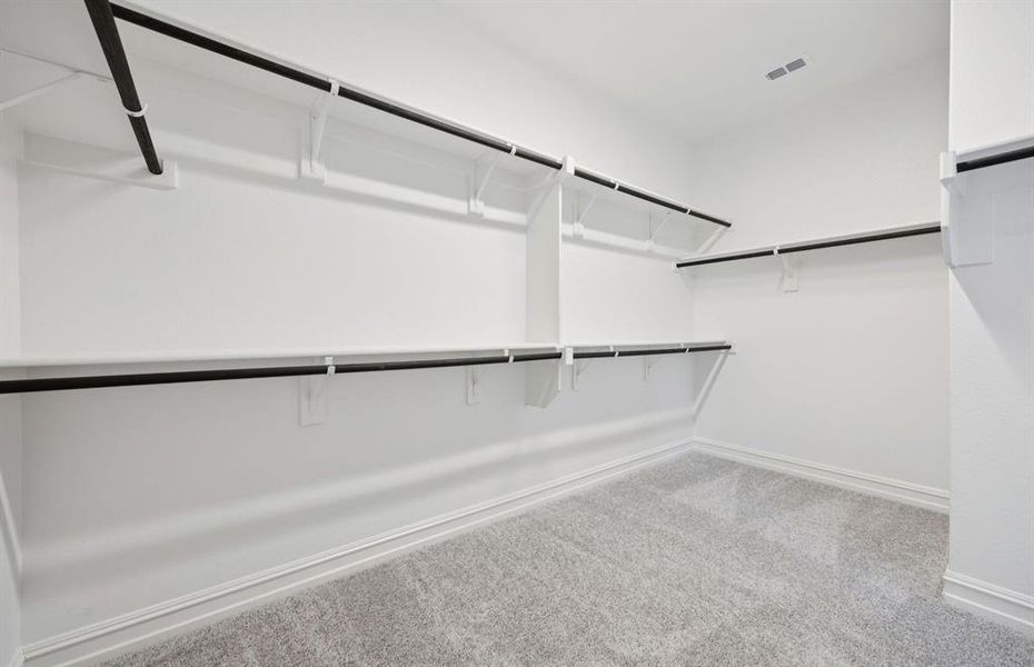 Expansive owner's closet designed for optimal organization Expansive owner's closet designed for optimal organization