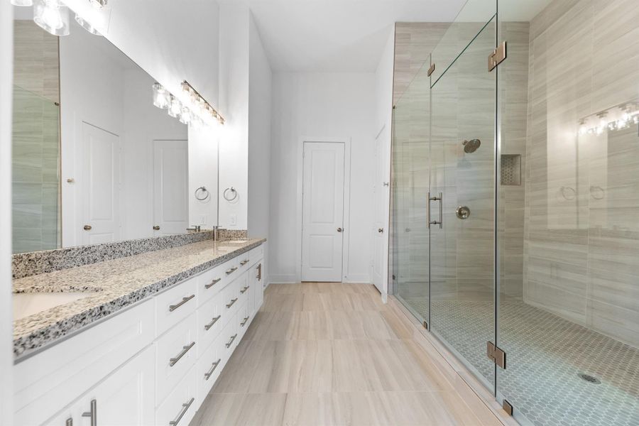 Primary bath features an extra-long vanity with dual sinks, providing ample space and convenience. Primary bath features an extra-long vanity with dual sinks, providing ample space and convenience.