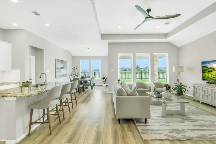 Open-concept living space showcasing 11-foot ceilings, premium interior paint, and unobstructed views of the lake.