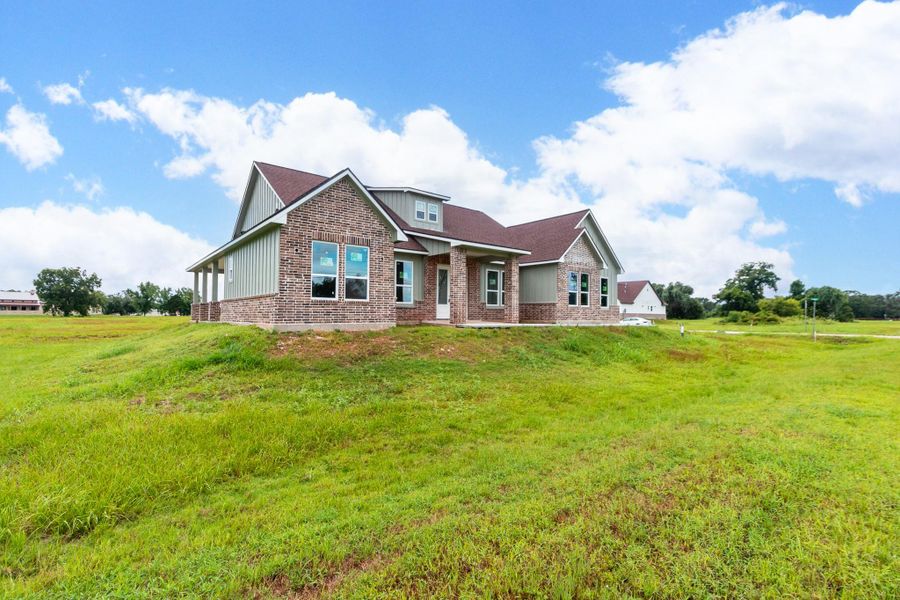 Charming brick home set on a spacious grassy lot, featuring a gabled roof and large windows for abundant natural light. Charming brick home set on a spacious grassy lot, featuring a gabled roof and large windows for abundant natural light.