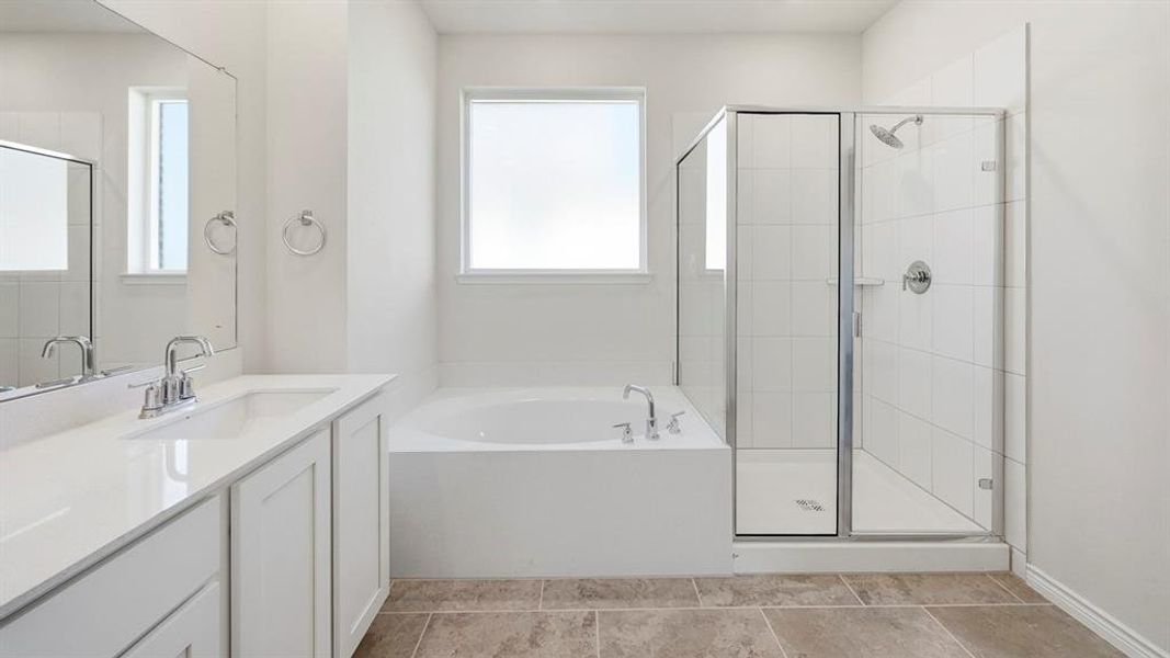 Bathroom featuring a garden tub, vanity, a shower stall, and light tile patterned flooring