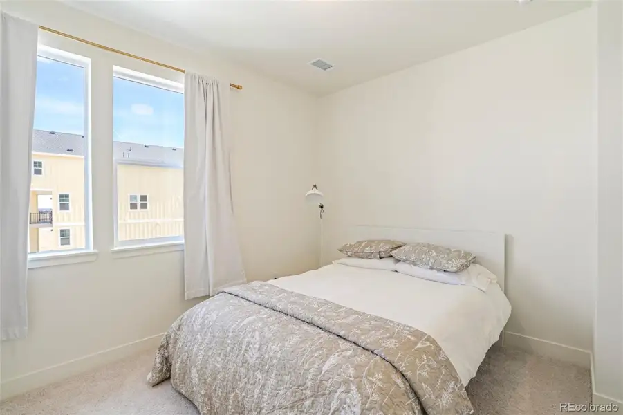 Comfortable secondary bedroom with natural light and neutral finishes, ideal for guests or flexible living in this Morrison home near Red Rocks
