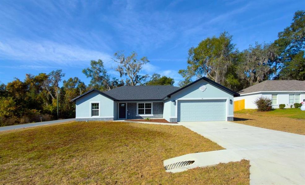 Front exterior of a new home in , Ocala, FL, highlighting curb appeal (Image 1).