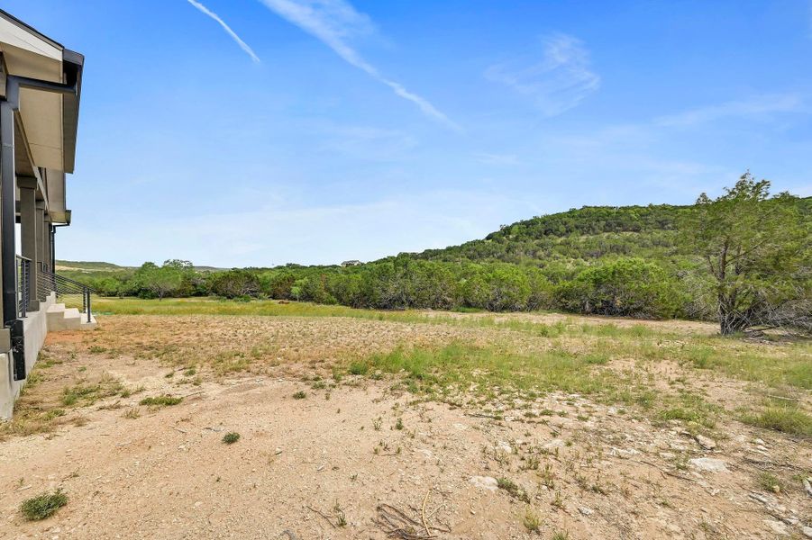 A large cleared backyard sits behind the home, stretching to the wooded acreage beyond the yard line. A large cleared backyard sits behind the home, stretching to the wooded acreage beyond the yard line.
