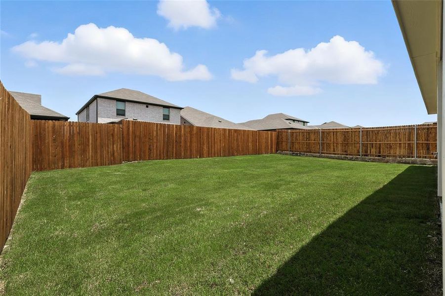View of fenced backyard