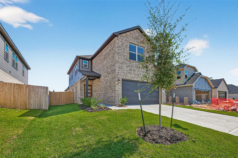 Front exterior of a new home in Mill Creek Trails, Magnolia, TX, highlighting curb appeal (Image 27).