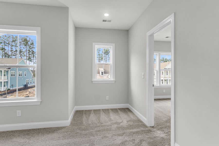 Spacious, unfurnished interior of a new home in Tidewater at Lakes of Cane Bay, Summerville (Image 58).