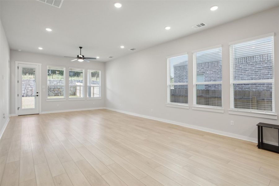 Unfurnished living room featuring light wood finished floors, visible vents, and recessed lighting